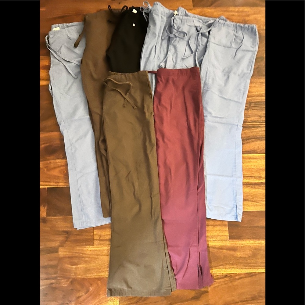 8 pairs of flare scrub pants with slits on the bottom